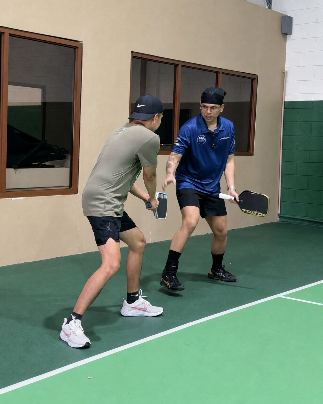 Coach GL demonstrating pickleball positioning to a student